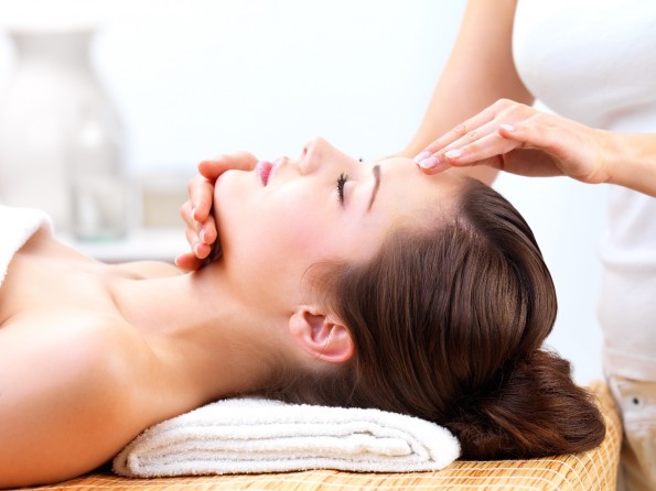 Hands massaging female face at the spa
